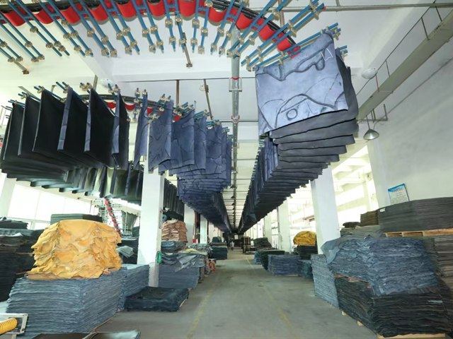 Factory material area with leather sheets and stacked production materials for material review