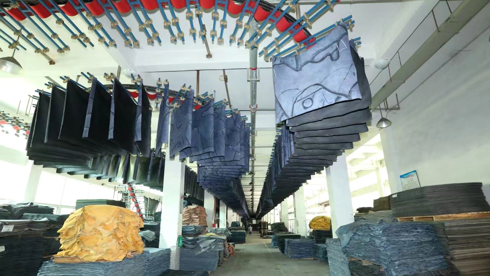 LEBO leather surface finishing area with hanging materials
