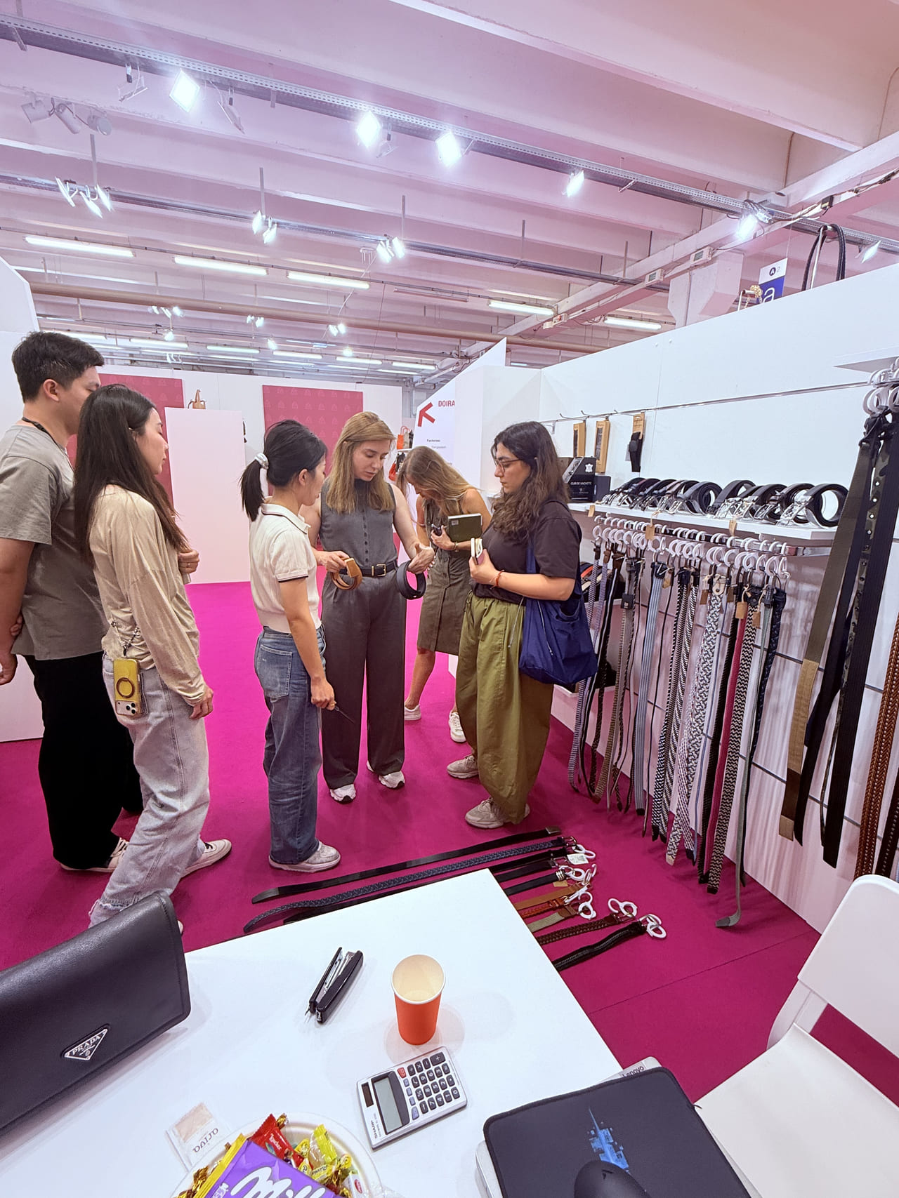 LEBO team presenting belt options to international visitors in Italy